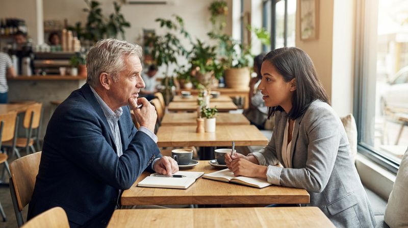 Mentor and mentee having a productive career conversation in a cafe